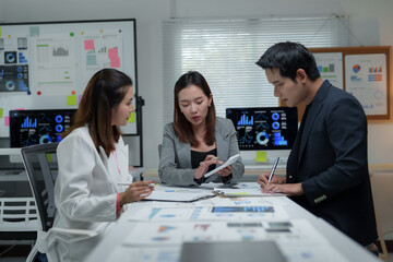 Fototapeta premium Business people working and discussing using calculator and documents in modern office