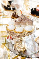 Delicious macarons and pastries decorating a luxurious candy bar buffet