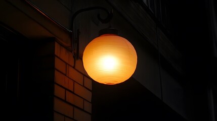 Warm Glowing Round Lantern Light on Brick Wall at Night