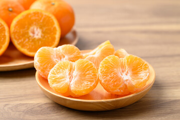 Mandarin tangerine orange fruit on wooden plate ready to eating
