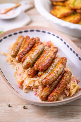 Nuremberg grilled small sausages with sauerkraut and crispy potato pancakes