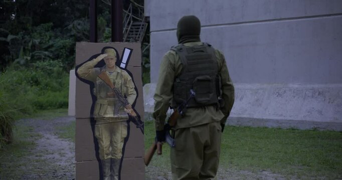 Suspicious soldier approaching box then saluting obviously fake military officer and turning back around - steady cam shot 