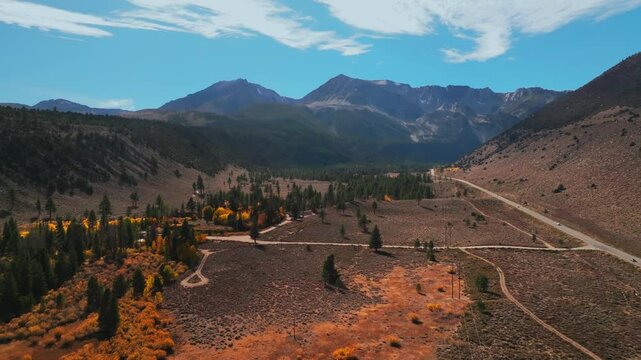 West Portal Entrance Lee Vining Tioga Pass Road Yosemite National Park Ansel Adams Wilderness Big Oak Flat California aerial drone fall autumn yellow orange Aspen Trees blue skies clouds cars circle