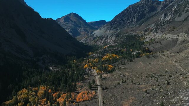 West Portal Entrance rugged Mountains Lee Vining Tioga Pass Road Yosemite National Park California aerial drone Ansel Adams Wilderness Big Oak Flat fall yellow orange Aspen Trees blue skies forward up
