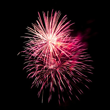 Colorful celebration fireworks isolated on black sky background.