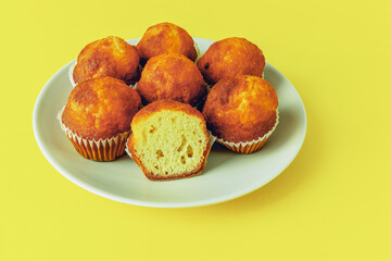 mini muffins in a plate on a yellow background