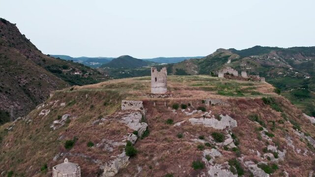 Drone on an ancient tower in Amantea, Italy. On a high hill on the seashore above the city. A cloudy summer day