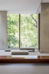 Fototapeta premium Natural light fills a minimalist interior design space with views of green trees outside