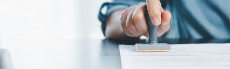 Banner of businessman hands stamp approve on financial business approval document paper. hand...