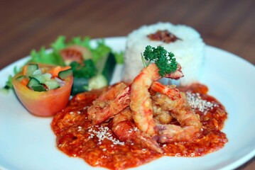 Delicious Fried Shrimp Dish with Rice and Salad on Plate