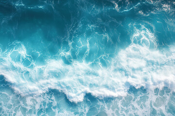 Fototapeta premium Aerial view of powerful turquoise ocean waves crashing in a dynamic, foamy pattern. 