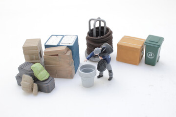 Miniature Scene Depicting Recycling Setup With a Person