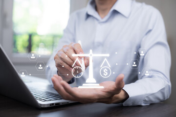 Businessman balancing time and money with a digital scale hologram. Concept of financial...