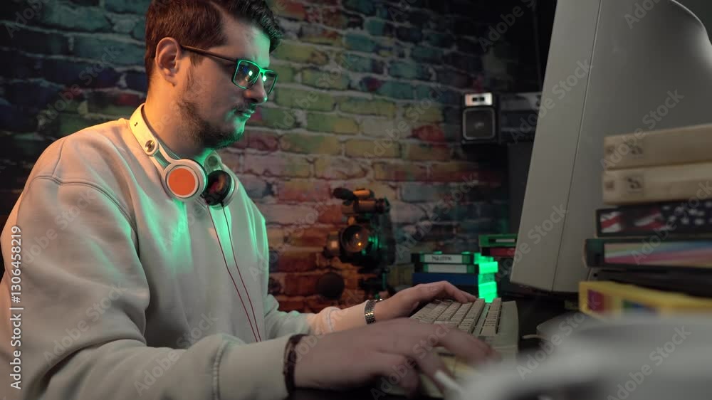 Poster video editor from 1990's working on desktop computer, vhs cassette tapes and camcorder on desk