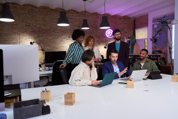 Marketing professionals collaborating on project in modern office