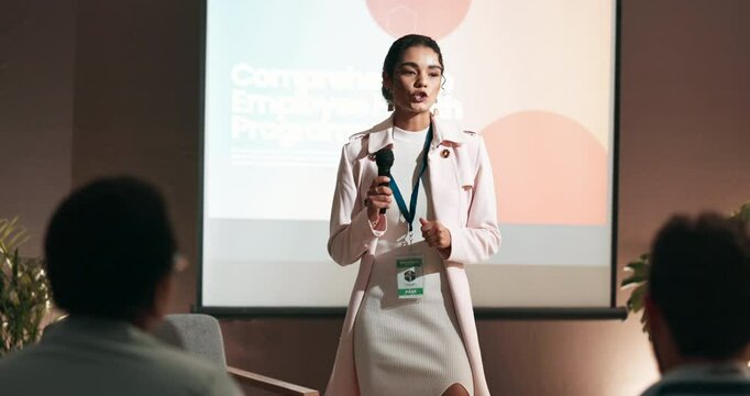 Seminar, audience or businesswoman with mic for talking, training or workshop for employees health. Crowd, presenter or program with speech for conference, presentation or workplace wellness on stage