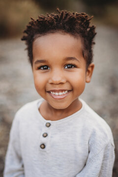 Portrait beautiful black 5 year old boy  smiling outside in sumer
