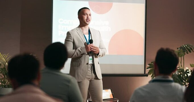 Conference, audience and businessman with mic for talking, training or workshop for employees health. Crowd, presenter and program with speech for seminar, presentation or workplace wellness on stage