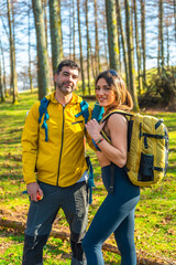 Fototapeta premium Hikers walking in forest enjoying trekking day