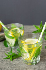 Mojito summer refreshing cocktail with ice and mint. mojito cocktail with lime, lemon and mint in a tall glass with a stick
