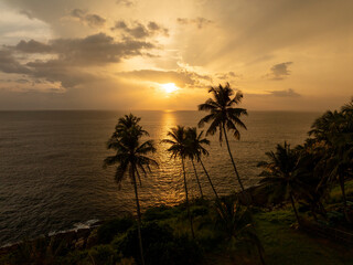 Tropical beach side in South coast of Sri Lank. Amazing sunset on the background over the Indian Ocean