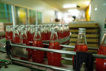 Juice in glass bottles in a factory for the food industry