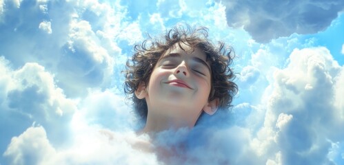 Young boy with curly hair his eyes closed and head tilted upwards towards the sky.