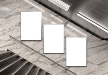 Three isolated billboards on underground wall. Frames in subway interior