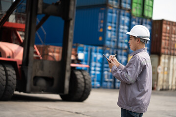 Asia engineer worker man working with checking container at container site	