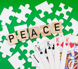 Peace wooden letters with puzzle , colors and cards