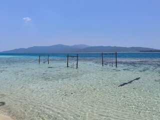 Swings installed above the clear sea water in Karimunjawa, Indonesia