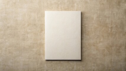 Fototapeta premium Blank Cream-Colored Rectangle on Textured Fabric Background Perfect for Mockups and Design Presentations