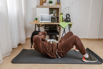 A man does sit-ups during a break at work.