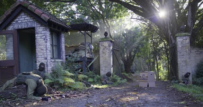 Strange box in dirt road at checkpoint with masked guards laying unconscious and WW2 military truck pulling up - wide shot
