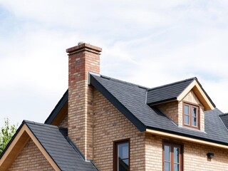 New home being constructed with asphalt tile roof and chimney, home construction, construction site