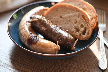 Traditional Czech dish featuring Masopust-style blood sausage (jelito) and white sausage (jitrnice), served with fresh rustic bread. 