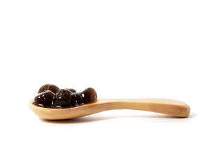 Brown sugar pearls bubble in wooden spoon isolated on white background