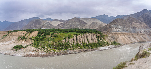 Scenic landscape panorama of Indus river valley and rock formations on overcast day near Chilas, Gilgit-Baltistan, Pakistan
