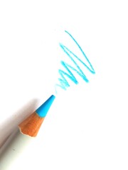 Close up of a coloured pencil tip and scribble on white paper.