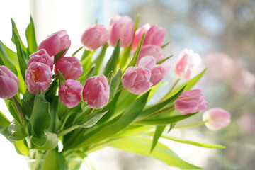 Fototapeta premium Bouquet of pink tulip flowers on spring sky background