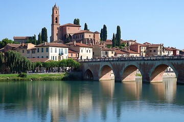 Obraz premium Medieval town spans river with arched stone bridge