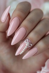 Elegant long nails showcase soft pink polish, adorned with delic