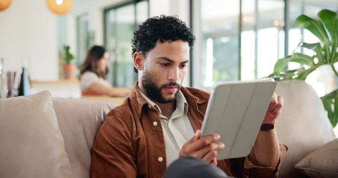 Thinking, relax and tablet with man on sofa for social media post, reading and online update. Networking, newsletter subscription and idea with person in living room at home for chat and scroll