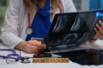 In a clinical environment, a radiologist expertly analyzes Xray images while using a stethoscope...