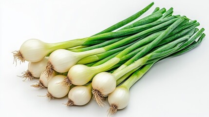 Fresh green onions with white bulbs are displayed on white