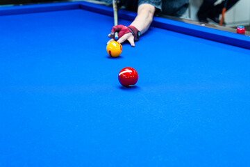 playing billiard on table