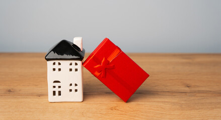 Miniature house and gift box. Housing as a gift. Win an apartment in the lottery. To inherit...