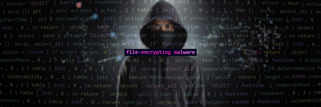 Cyber attack file-encrypting malware text in foreground screen, hacker hidden in the blurred background. Vulnerability text in binary system ascii art style, code on editor screen. Text in English