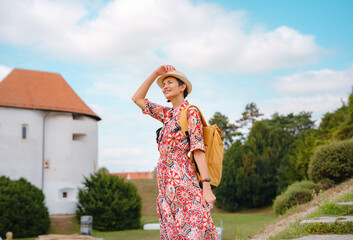 Beautiful woman walking of Varazdin streets during summer day in old, historical city center....