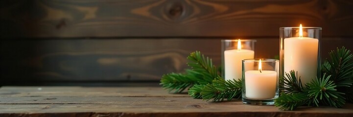 Pine branches and candles in mercury glass holders, rustic decor,, wooden background